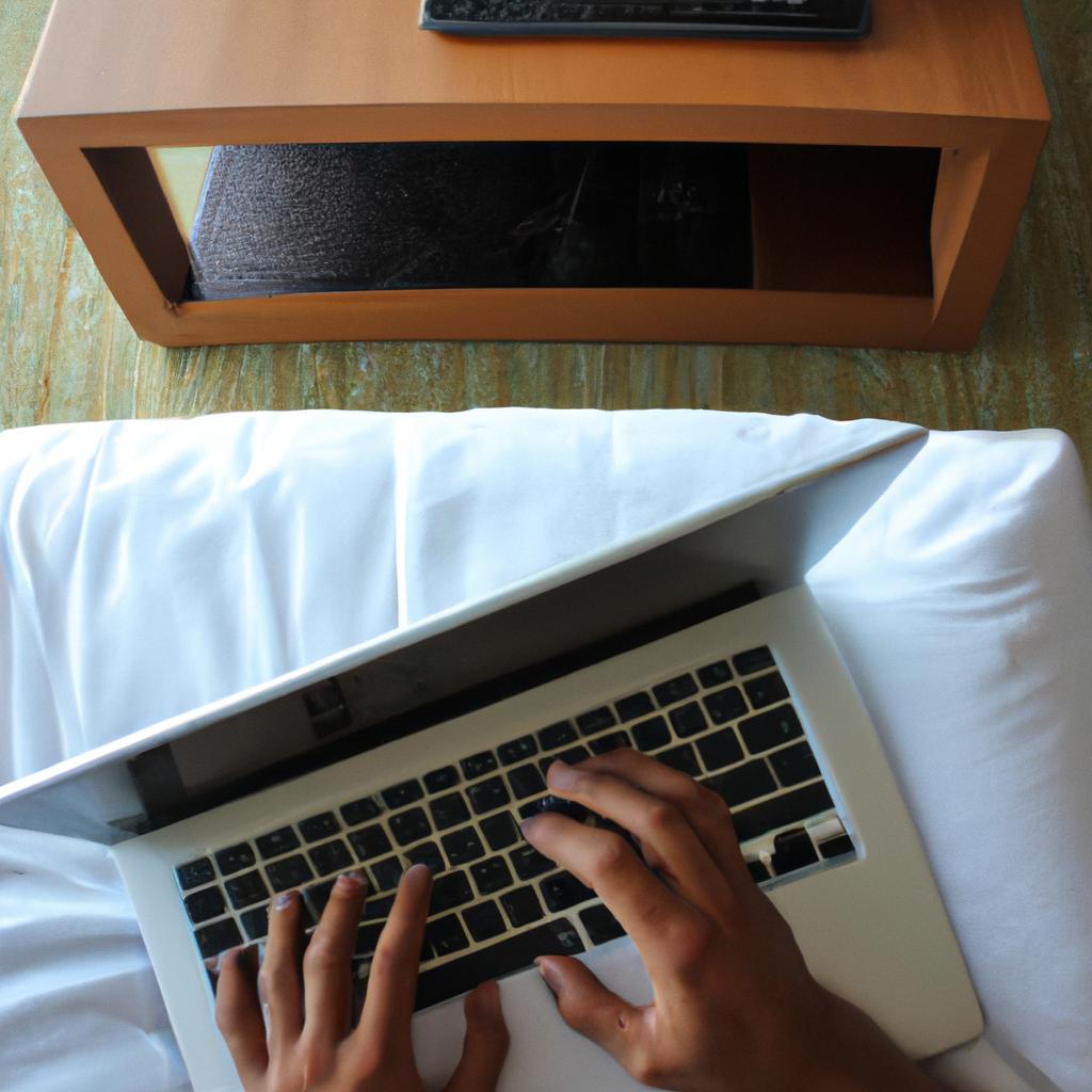 Person using laptop in hotel